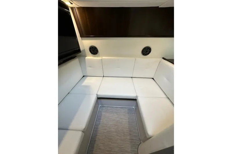 Slide: The Image of Interior of 2021 Cruisers Yachts 338 South Beach Edition, featuring white cushioned seating. - 17