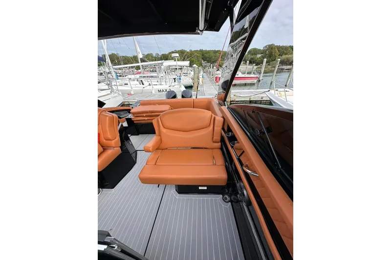 Slide: The Image of 2021 Cruisers Yachts 338 South Beach Edition Bow Rider interior with tan leather seating. - 29