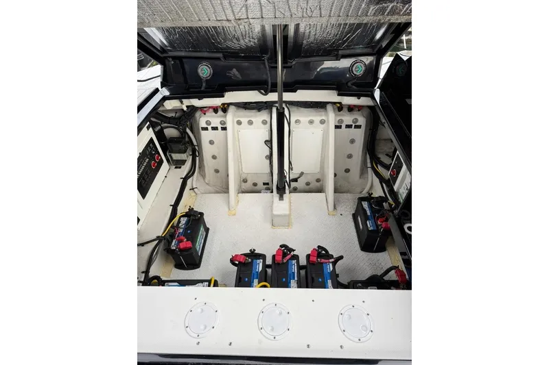 Slide: The Image of Engine compartment of 2021 Cruisers Yachts 338 South Beach Edition Bow Rider with visible batteries. - 39