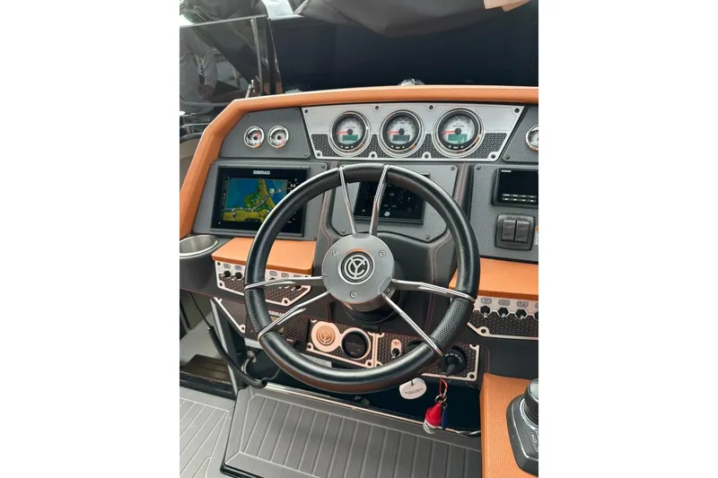 Slide: The Image of 2021 Cruisers Yachts 338 South Beach Edition Bow Rider dashboard with steering wheel and controls. - 4