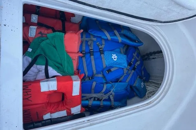 Slide: The Image of Life jackets stored in a 2015 Comercial Water Sports Ocean Pro 31 boat compartment. - 15