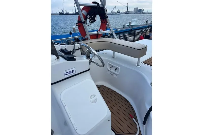 Slide: The Image of 2015 Comercial Water Sports Ocean Pro 31 boat interior with steering wheel and seating. - 22