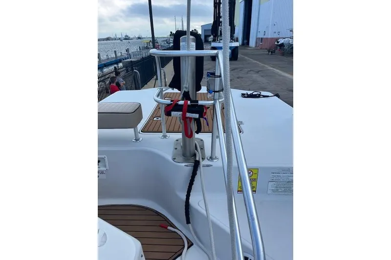 Slide: The Image of 2015 Comercial Water Sports Ocean Pro 31 boat docked, featuring deck and railing details. - 23