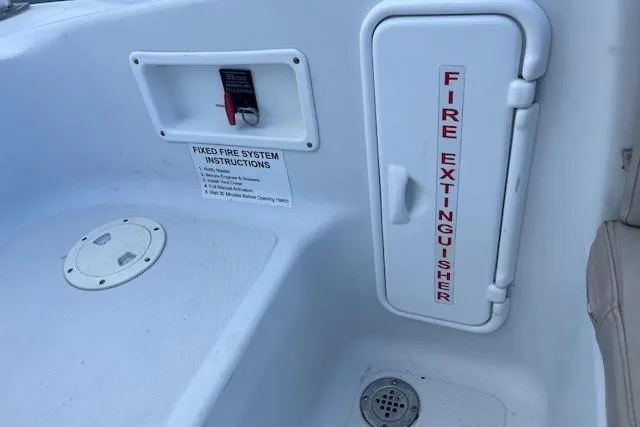 Slide: The Image of Fire extinguisher compartment on 2015 Comercial Water Sports Ocean Pro 31 boat. - 24