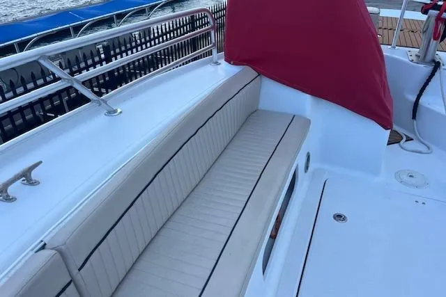 Slide: The Image of 2015 Comercial Water Sports Ocean Pro 31 boat with cushioned seating and red cover. - 30