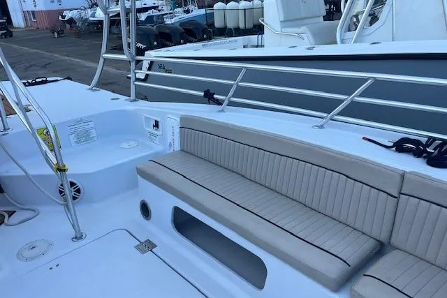 Slide: The Image of 2015 Comercial Water Sports Ocean Pro 31 boat interior with cushioned seating. - 31