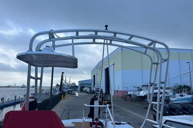 Slide: The Image of 2015 Comercial Water Sports Ocean Pro 31 boat docked near industrial warehouse. - 32