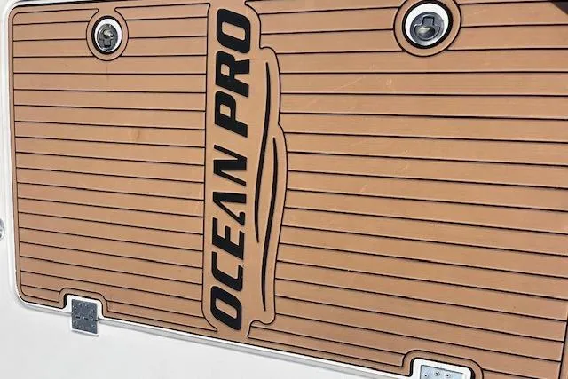 Slide: The Image of Comercial Water Sports Ocean Pro 31 boat deck, 2015 model, featuring sleek design and branding. - 4