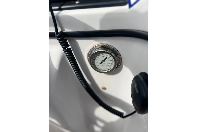 Slide: The Image of Close-up of a pressure gauge on a 2015 Comercial Water Sports Ocean Pro 31 boat. - 6
