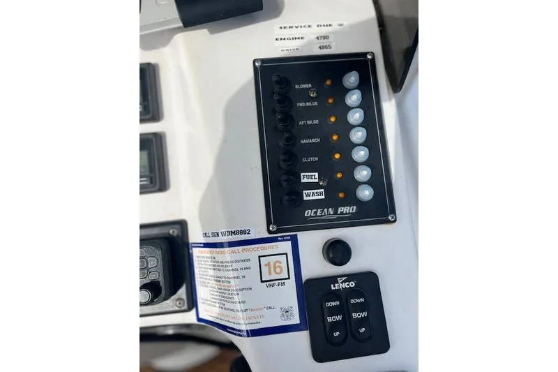Slide: The Image of Control panel of 2015 Comercial Water Sports Ocean Pro 31 boat with switches and radio procedures. - 7