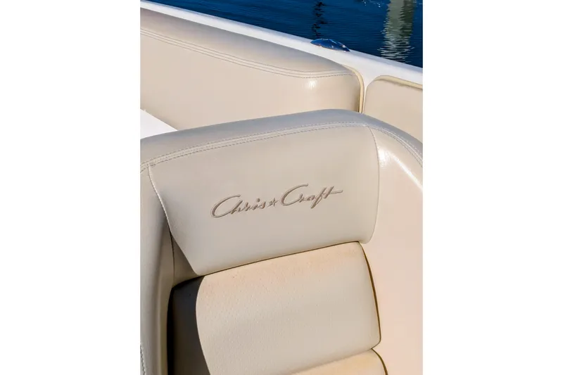 Slide: The Image of Close-up of 2008 Chris-Craft Launch 25 boat seat with logo, near water. - 10