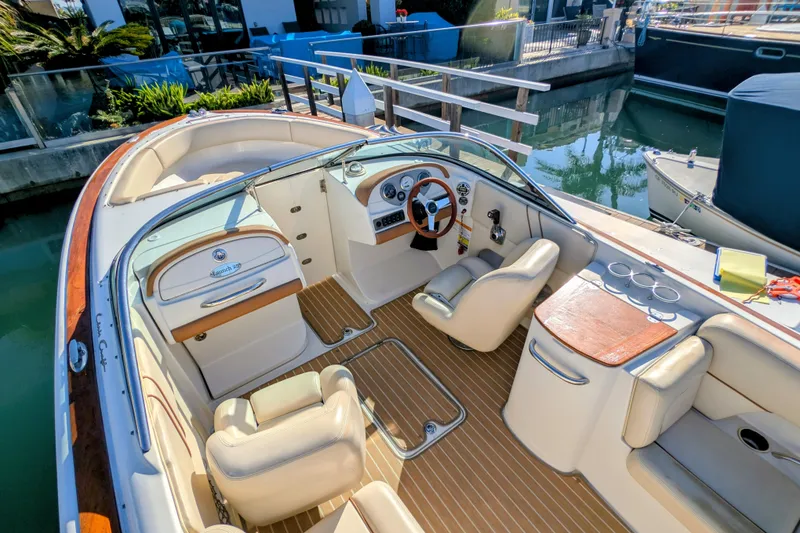 Slide: The Image of 2008 Chris-Craft Launch 25 boat interior with elegant seating and wooden accents. - 11