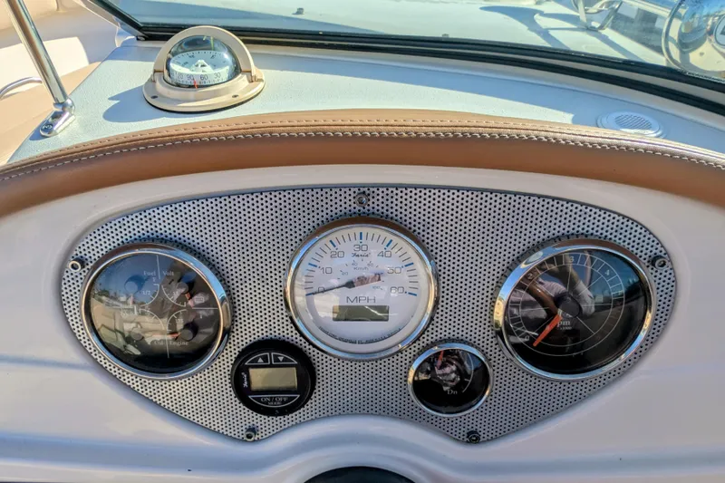 Slide: The Image of Dashboard of 2008 Chris-Craft Launch 25 boat with gauges and compass. - 13