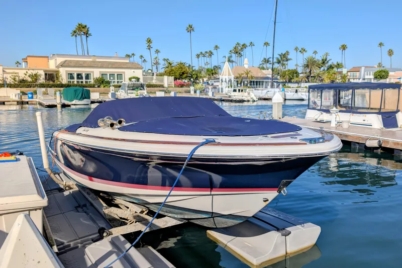 Slide: The Image of 2008 Chris-Craft Launch 25 boat docked in a sunny marina setting. - 15