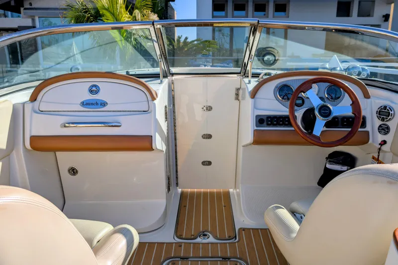 Slide: The Image of 2008 Chris-Craft Launch 25 boat interior with steering wheel and dashboard controls. - 16