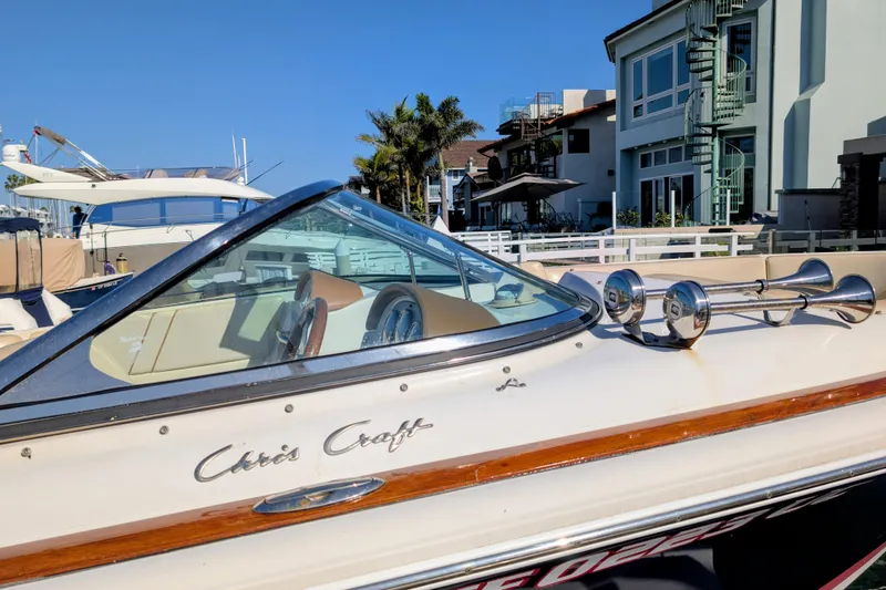 Slide: The Image of 2008 Chris-Craft Launch 25 boat docked near waterfront homes. - 22