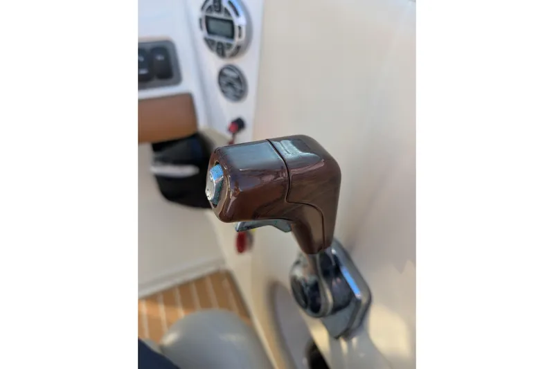 Slide: The Image of Close-up of 2008 Chris-Craft Launch 25 throttle control on boat dashboard. - 24