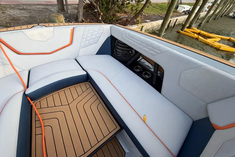 Slide: The Image of 2022 Nautique Super Air Nautique G25 interior with stylish seating and teak flooring. - 16