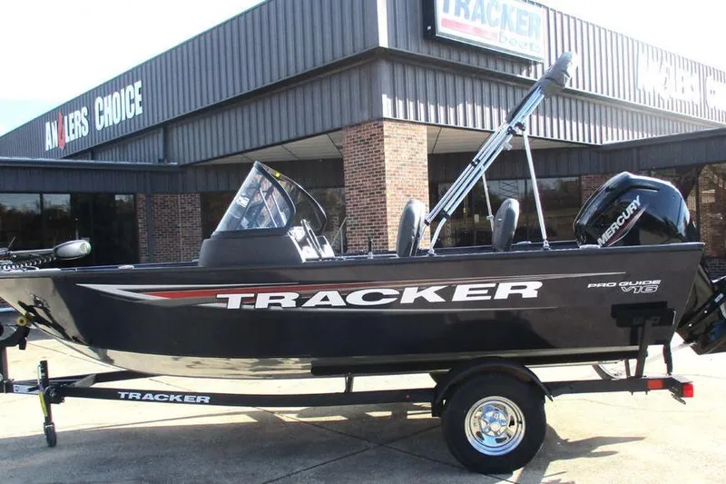 The Image of 2026 Tracker Pro Guide V-16 WT boat displayed outside dealership. - 1