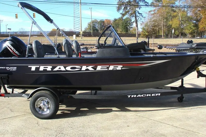 Slide: The Image of 2026 Tracker Pro Guide V-16 WT boat on trailer, outdoors, side view. - 6