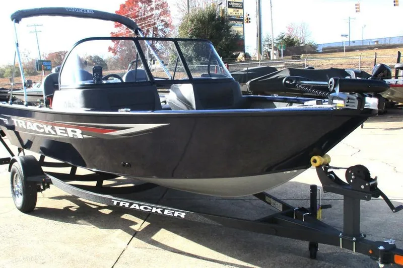 Slide: The Image of 2026 Tracker Pro Guide V-16 WT boat on trailer, parked outdoors. - 8