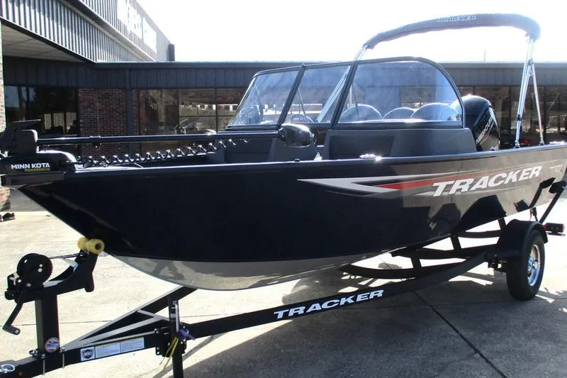 Slide: The Image of 2026 Tracker Pro Guide V-16 WT boat on trailer, parked outdoors. - 9