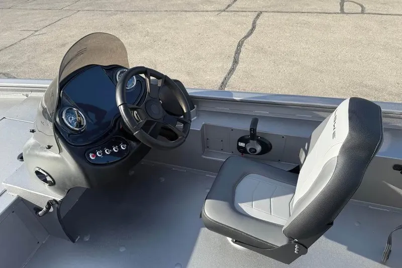 Slide: The Image of 2026 Lowe Outlet 20 boat cockpit with steering wheel and seat. - 10