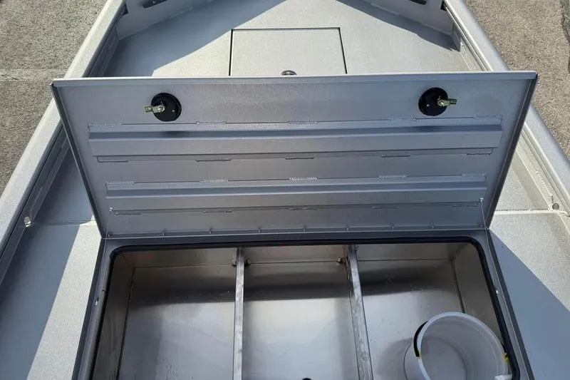 Slide: The Image of Open storage compartment in 2026 Lowe Outlet 20 boat, featuring a spacious interior. - 14