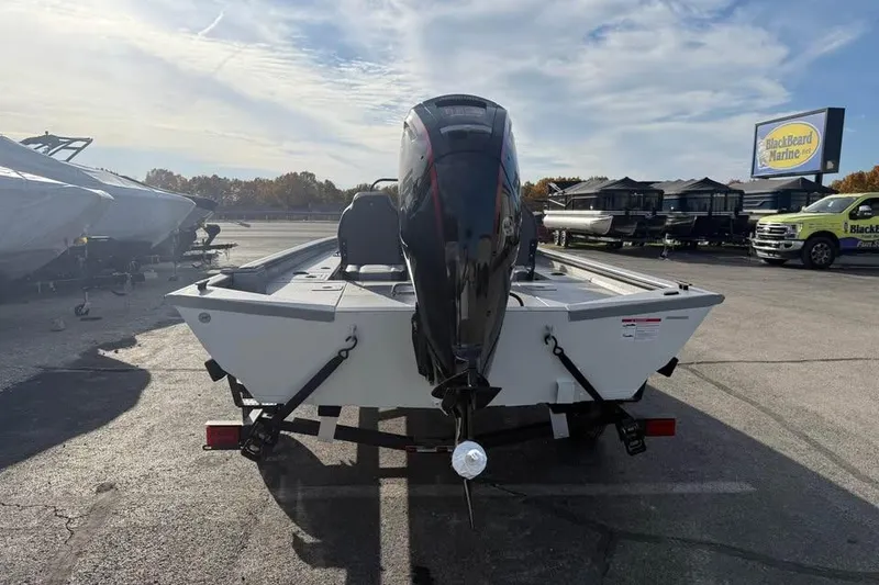 Slide: The Image of 2026 Lowe Outlet 20 boat with motor, parked outdoors at a marine dealership. - 6