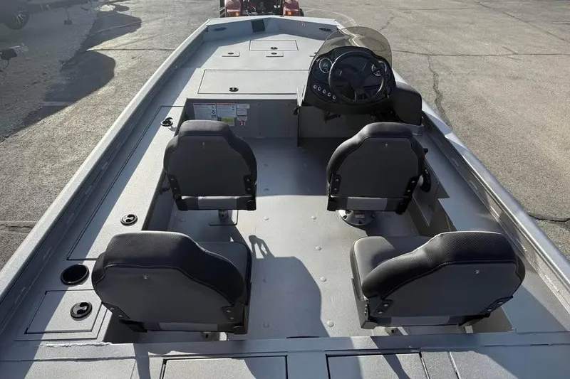 Slide: The Image of Interior of a 2026 Lowe Outlet 20 boat with four seats and steering console. - 9