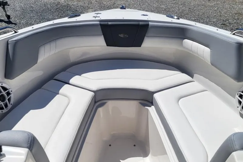 Slide: The Image of 2022 Chaparral 23 SSi boat interior with cushioned seating and sleek design. - 12