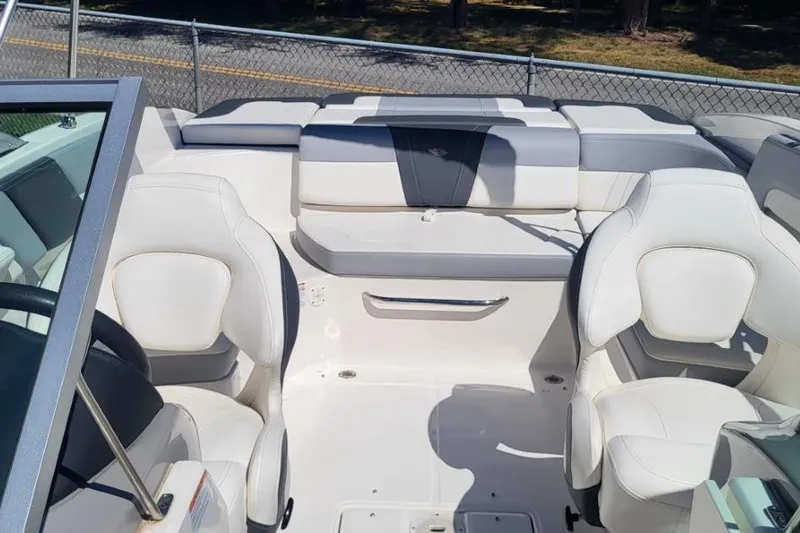 Slide: The Image of 2022 Chaparral 23 SSi boat interior with white seating and modern design. - 4
