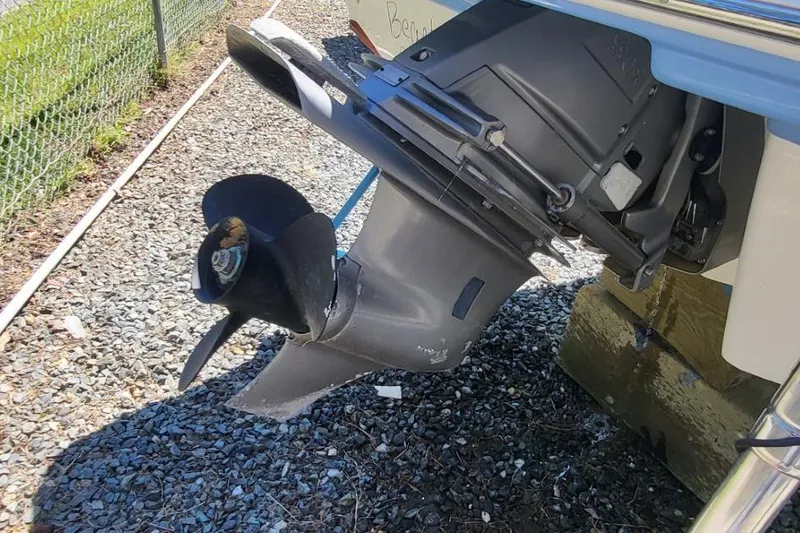 Slide: The Image of 2022 Chaparral 23 SSi boat propeller and outdrive on gravel surface. - 8