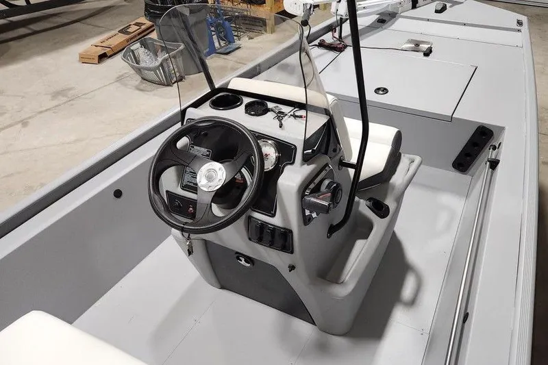 Slide: The Image of 2026 Tracker Bass Tracker Classic CC boat interior with steering console and seating. - 10