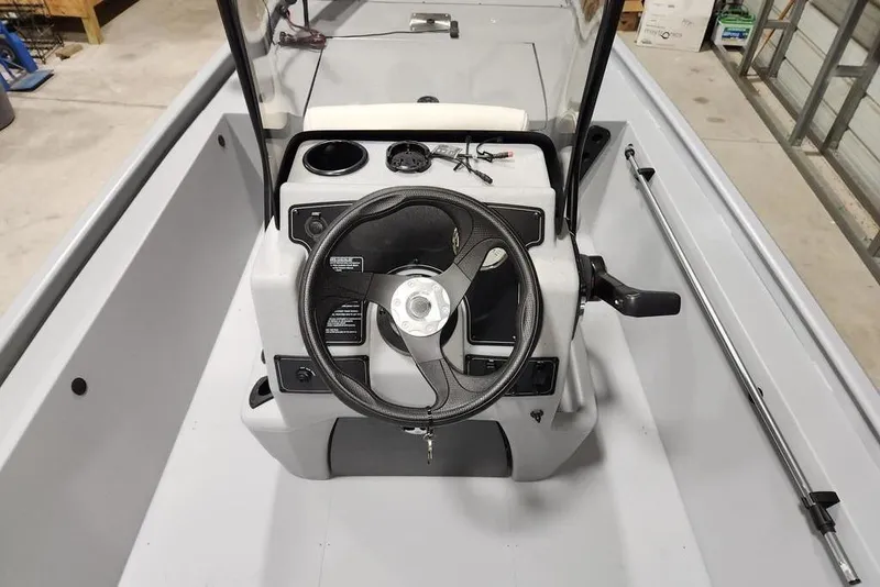 Slide: The Image of 2026 Tracker Bass Tracker Classic CC boat console with steering wheel and controls. - 3