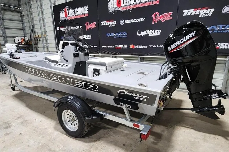 Slide: The Image of 2026 Tracker Bass Tracker Classic CC boat with Mercury engine in showroom. - 4