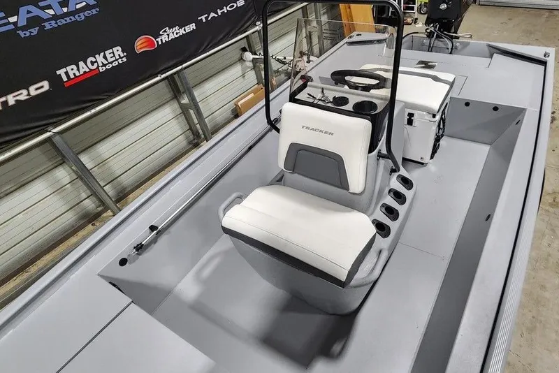 Slide: The Image of 2026 Tracker Bass Tracker Classic CC boat interior with steering console and seating. - 8