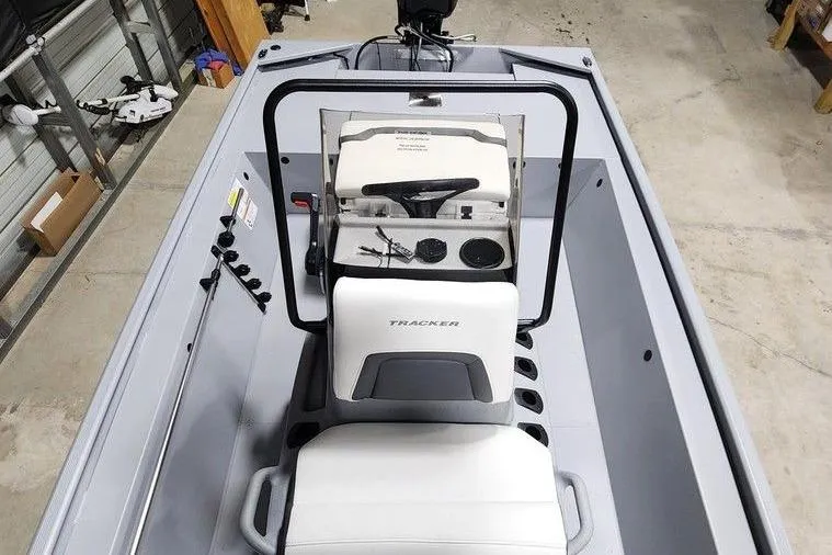 Slide: The Image of 2026 Tracker Bass Tracker Classic CC boat interior with steering console and seating. - 9