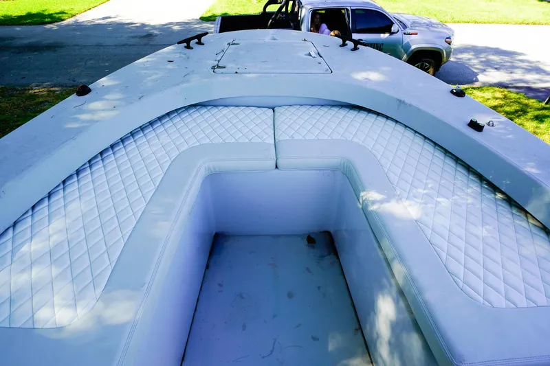 Slide: The Image of 2005 Boston Whaler 260 Justice boat interior with white cushioned seating and diamond pattern. - 13