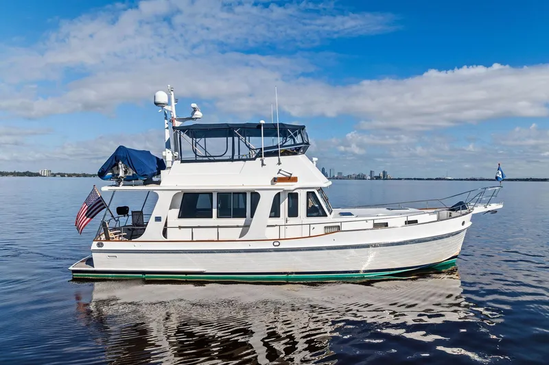 The Image of 2006 Grand Banks Europa 47 yacht cruising on calm waters under a clear blue sky. - 0