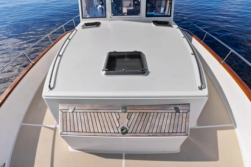 Slide: The Image of 2006 Grand Banks Europa 47 yacht deck with wooden accents and ocean view. - 10