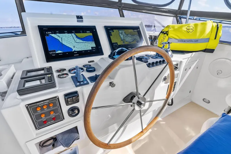 Slide: The Image of Helm of 2006 Grand Banks Europa 47 with navigation screens and wooden steering wheel. - 18