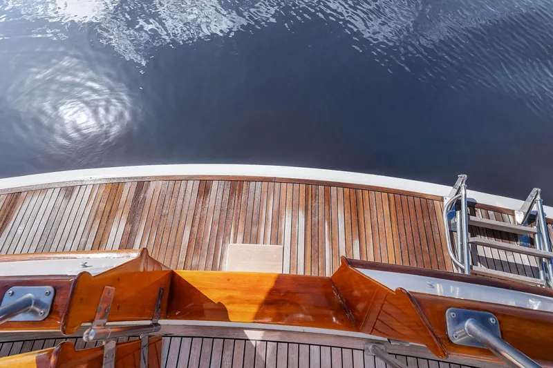 Slide: The Image of Teak deck of 2006 Grand Banks Europa 47 yacht with water reflection. - 23