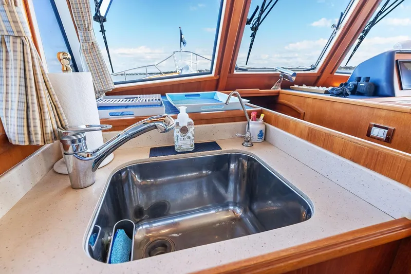 Slide: The Image of Galley sink area on 2006 Grand Banks Europa 47 yacht with ocean view. - 34