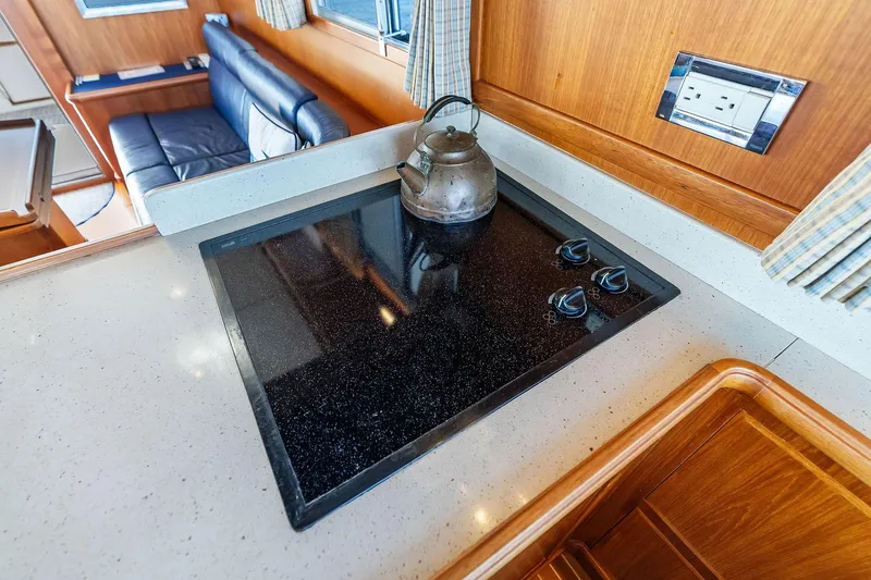 Slide: The Image of 2006 Grand Banks Europa 47 yacht kitchen with stovetop and kettle. - 35