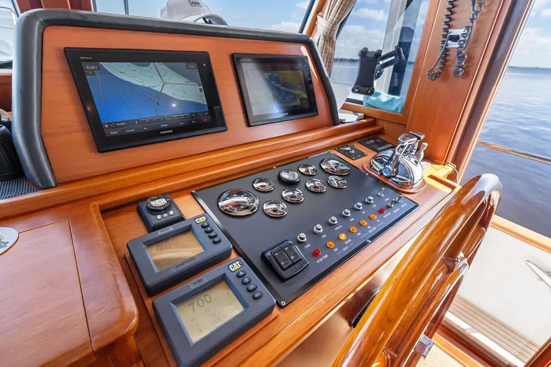 Slide: The Image of Helm of 2006 Grand Banks Europa 47 yacht with navigation screens and controls. - 39
