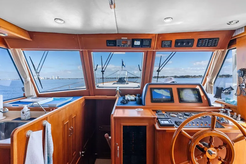 Slide: The Image of 2006 Grand Banks Europa 47 yacht helm with wooden dashboard and navigation equipment. - 40