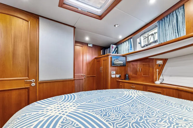 Slide: The Image of Luxurious 2006 Grand Banks Europa 47 yacht cabin with elegant wood finish and modern amenities. - 42