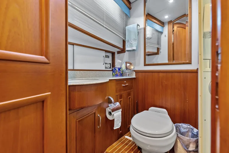 Slide: The Image of Luxurious 2006 Grand Banks Europa 47 yacht bathroom with wooden cabinetry and modern fixtures. - 43