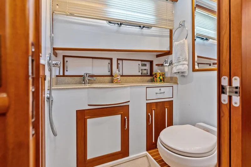 Slide: The Image of Luxurious bathroom in 2006 Grand Banks Europa 47 yacht with wood accents and modern fixtures. - 47
